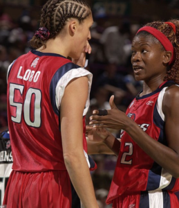Houston Comets teammates Rebecca Lobo and Sheryl Swoopes talk strategy midway through a game in 2002.